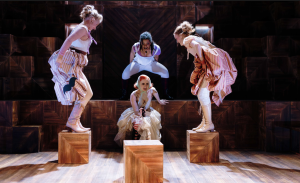 Cast of Mary and the Hyenas in costume, jump in the air